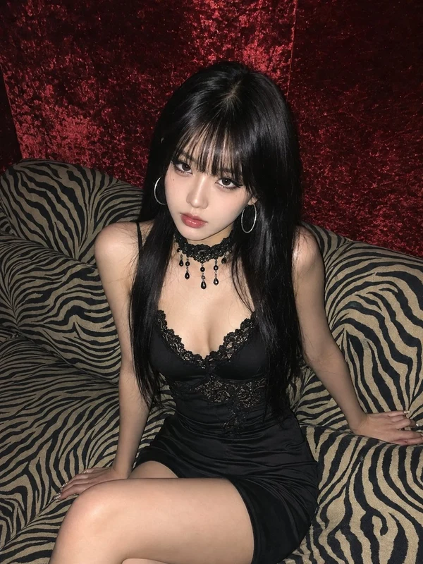 Adult woman in a black evening dress on a zebra-pattern sofa